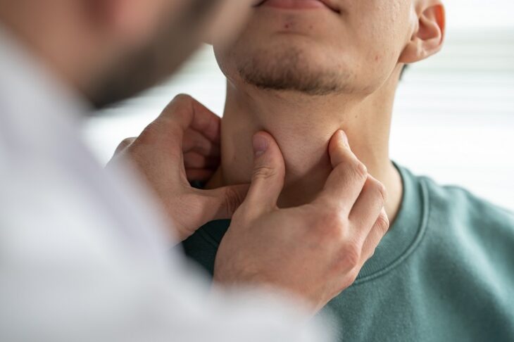 Doctor examining patient's throat